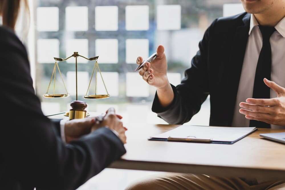 Lawyer discussing mediation benefits with a client