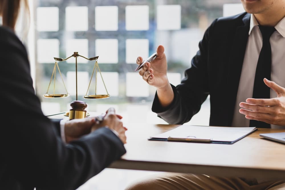 Lawyer discussing mediation benefits with a client